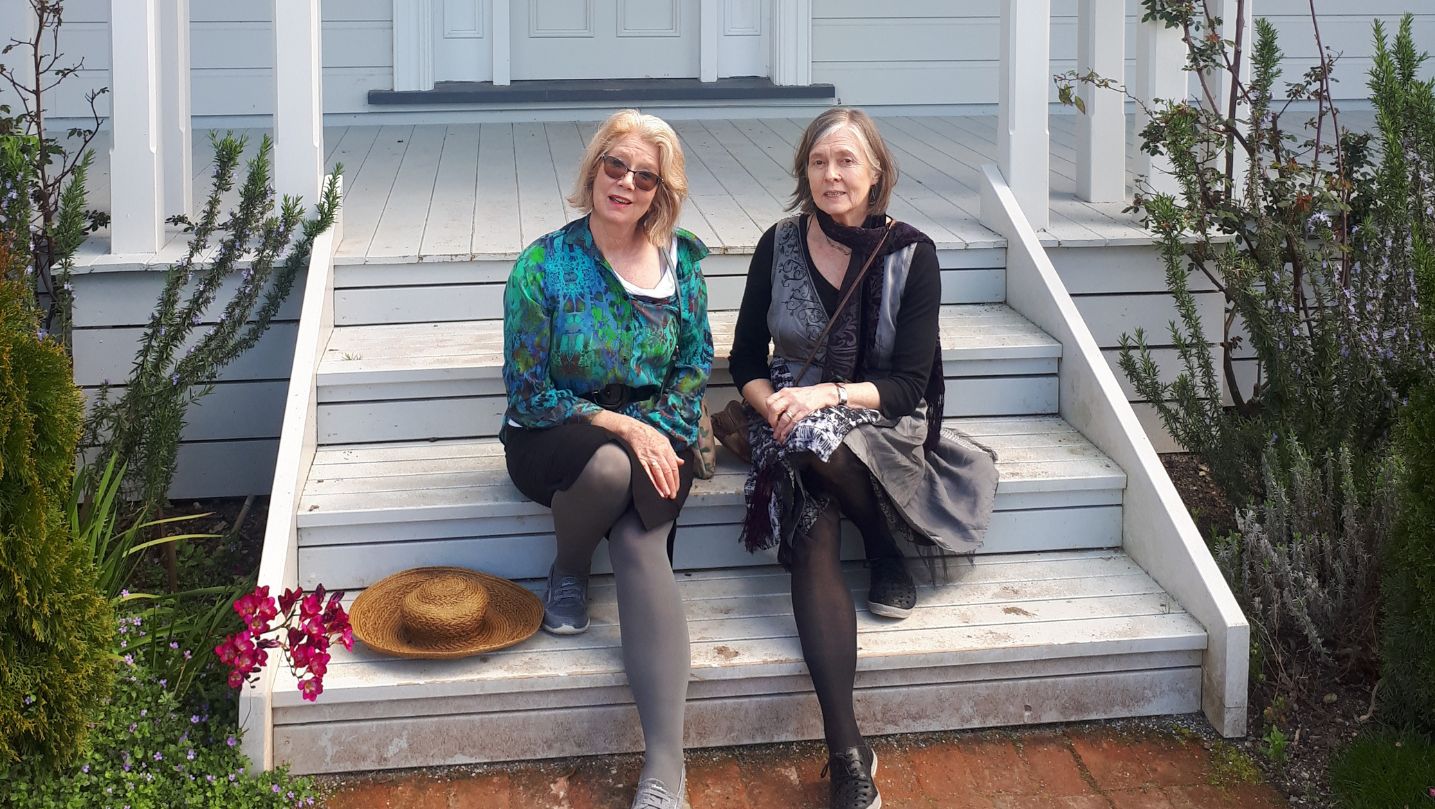 Sally and Gill sitting on the stairs outside Katherine Mansfield's house.